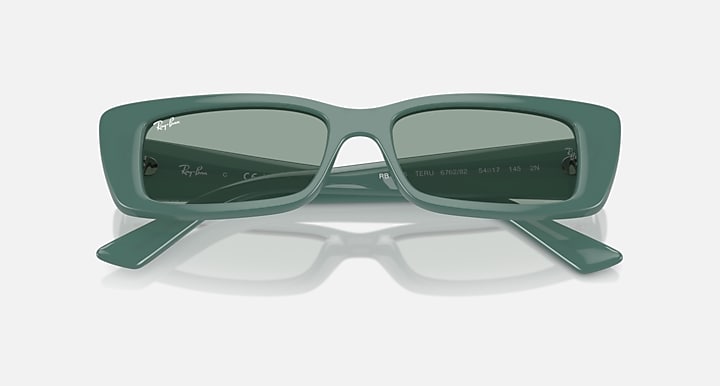 Green rectangular sunglasses with muted-green lenses, top view with temple text visible