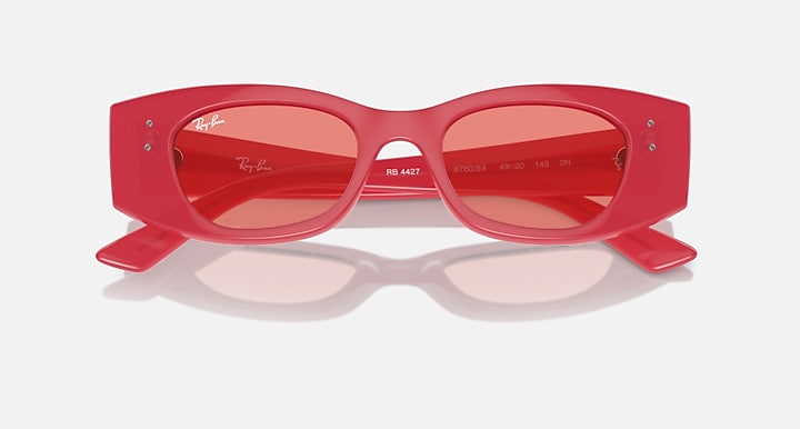 Red sunglasses front view with pink-tinted lenses and visible internal lens text