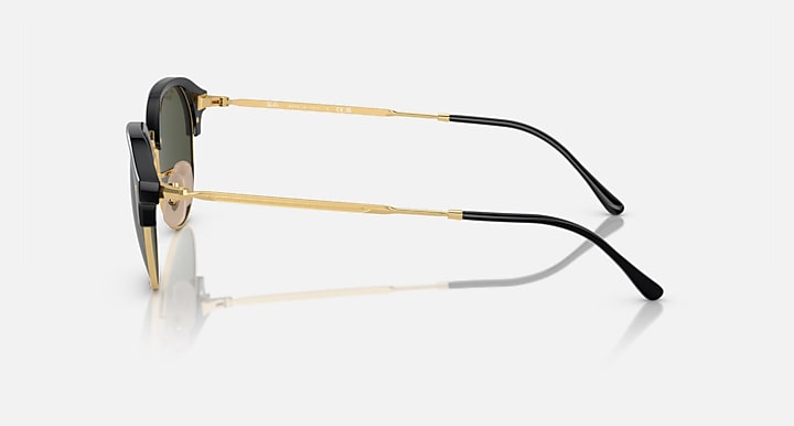 Side view of round sunglasses with black frame and gold temples