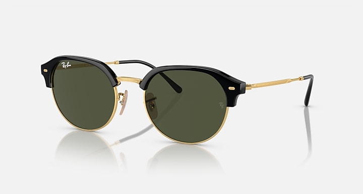 Round sunglasses with black frame, gold accents, and dark green tinted lenses