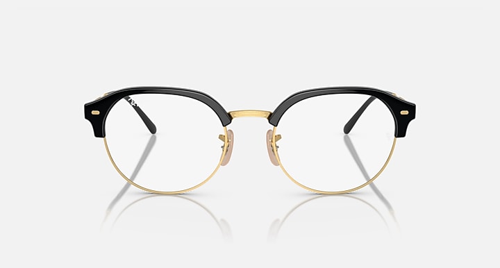 Ray-Ban RB4429 round sunglasses, black frame with gold bridge and clear lenses