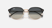 Round sunglasses with black frame and rose-gold rim, gray tinted lenses
