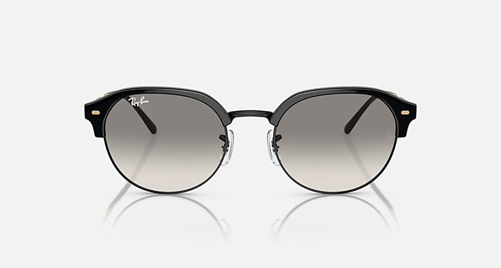Round sunglasses with black frame and dark grey tinted lenses, front view.