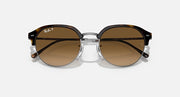 Round sunglasses with dark frame, brown lenses, and silver hinge bridge, front view.