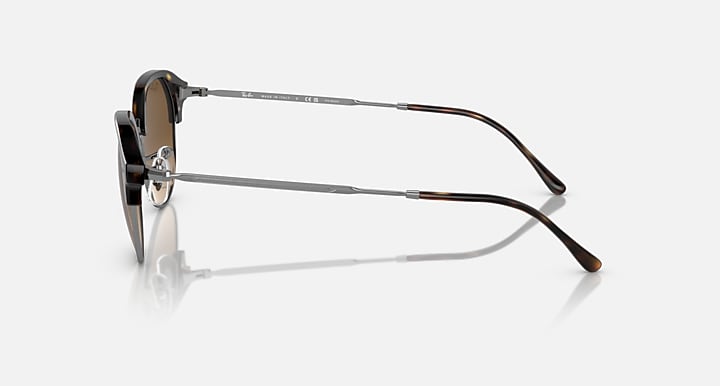 Round sunglasses side profile with black frame and silver metal bridge and arms.