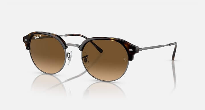 Round sunglasses with dark frame, brown/tan mirror lenses, and gold metal arms.