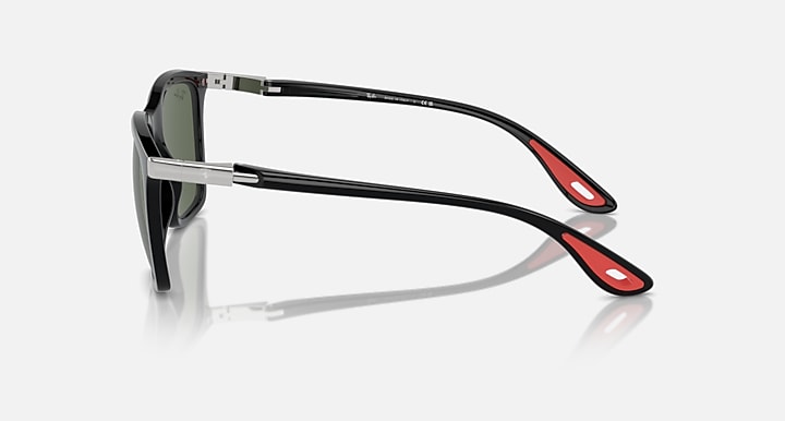 Black sunglasses showing side arms with dark green lenses and metal hinges