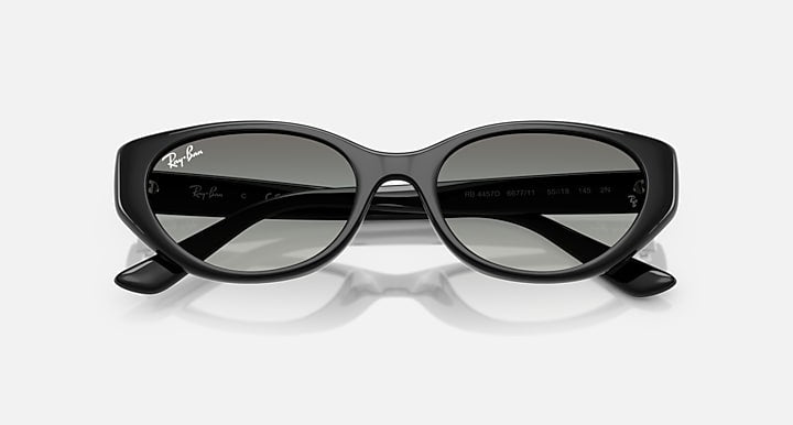 Black cat-eye sunglasses with dark gray gradient lenses and printed temple markings