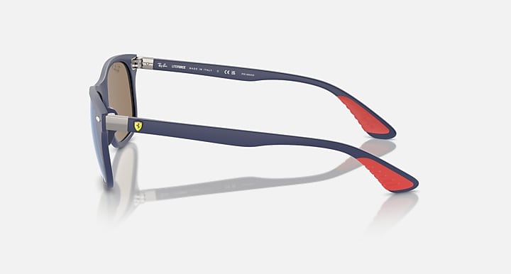 Ray-Ban dark navy sunglasses side profile with blue lens and red temple insert