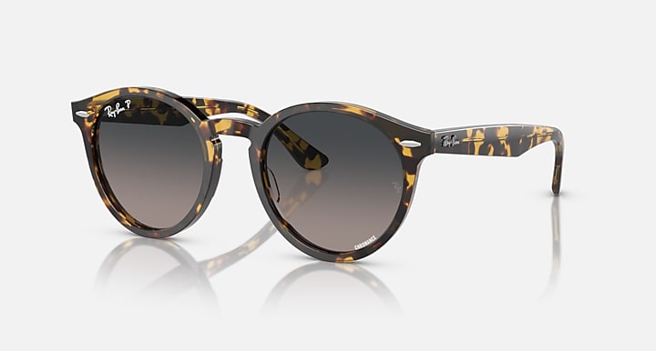 Tortoise round sunglasses with dark grey gradient lenses and slim metal hinge arms