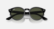 Ray-Ban round sunglasses with dark frames and green-tinted lenses, angled front