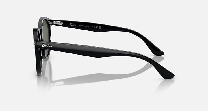Ray-Ban sunglasses side profile with dark frame and green-tinted lens