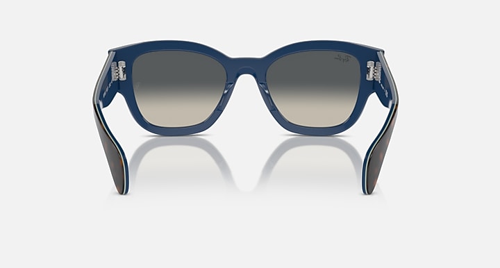 Blue sunglasses with grey gradient lenses and sculpted temple arms