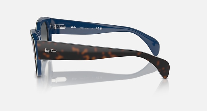Blue sunglasses side view with dark gradient lenses and branded temple