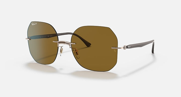 Sunglasses with brown mirrored lenses, silver metal frame, and curved temple arms