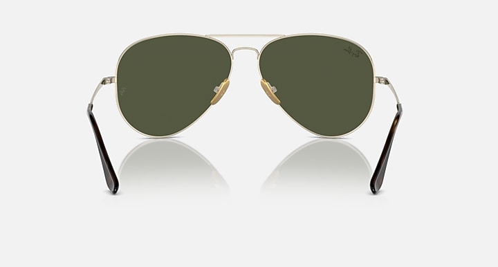 Ray-Ban aviator sunglasses with dark green tinted lenses and gold metal frame, front view