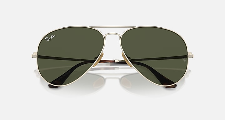 Ray-Ban aviator sunglasses with dark green tinted lenses and black temple arms, front view