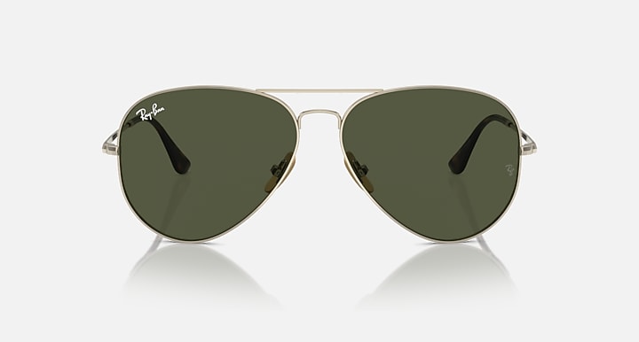 Ray-Ban aviator sunglasses with dark green tinted lenses, front view on gold frame