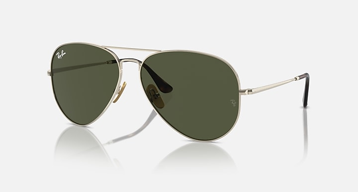 Ray-Ban aviator sunglasses with dark green tinted lenses and gold metal frame