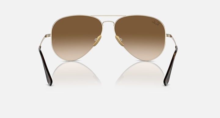 Ray-Ban aviator sunglasses with brown tinted lenses and gold metal frame, front view