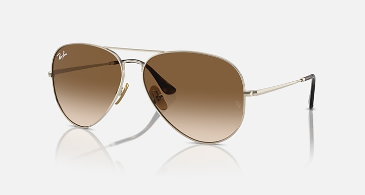 Ray-Ban aviator sunglasses with brown gradient tinted lenses and gold metal frame