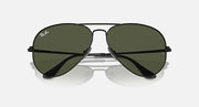 Aviator sunglasses with dark green lenses and matte black frame, mirrored front view