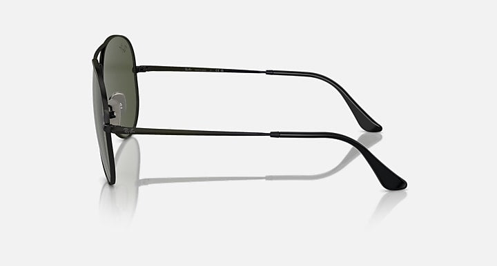 Aviator sunglasses with dark green lenses and matte black frame, side angle view