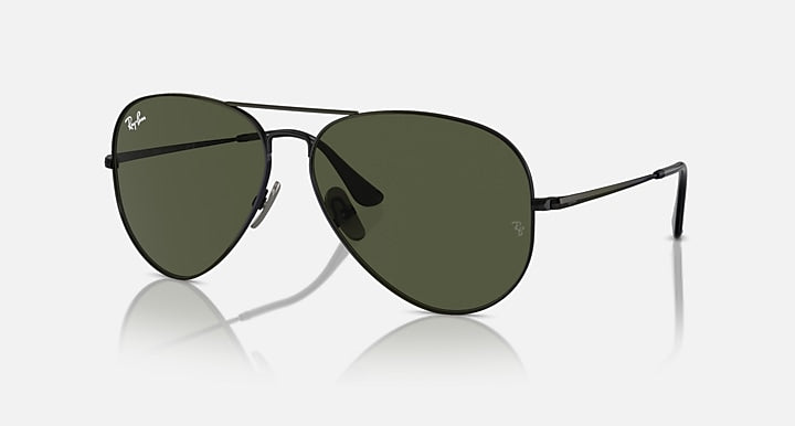 Aviator sunglasses with dark green lenses and matte black frame, side profile view