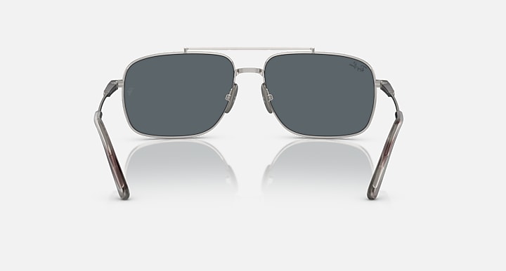 Silver metal rectangle sunglasses with dark gray lenses and curved brow arms