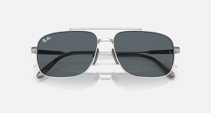 Silver metal wayfarer-style sunglasses with dark gray lenses and Ray-Ban logo