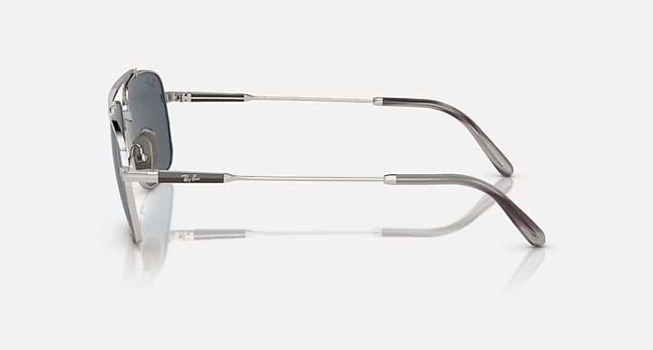 Silver metal sunglasses side view with dark gray lens and curved temple arms