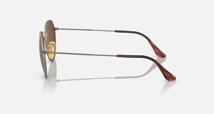 Round sunglasses side view with gold metal frame and brown gradient lens