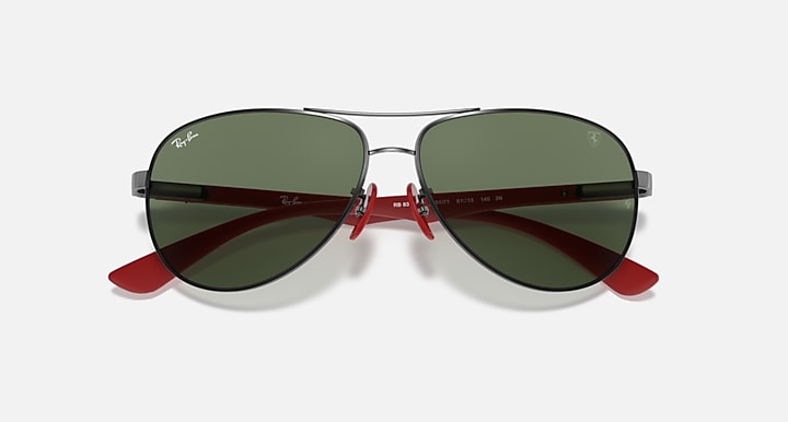 Ray-Ban aviator sunglasses, dark green mirrored lenses with gunmetal frame and red detail.