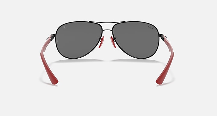Ray-Ban aviator sunglasses, black frame with dark grey lenses and red arms.