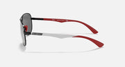 Ray-Ban aviator sunglasses side view, black frame with grey mirror lenses and red temple tip.