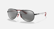 Ray-Ban aviator sunglasses side view, black frame with grey mirror lenses and red accents.