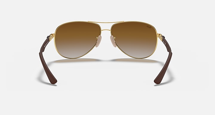 Ray-Ban aviator sunglasses with gold frame, brown gradient lenses, dark temples
