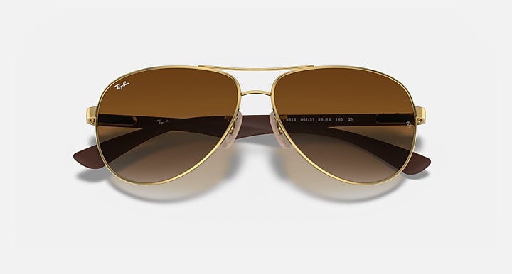Ray-Ban aviator sunglasses with gold frame and dark brown gradient lenses