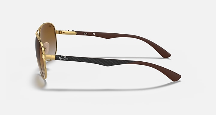 Ray-Ban aviator sunglasses, gold frame with brown carbon-fiber style temples