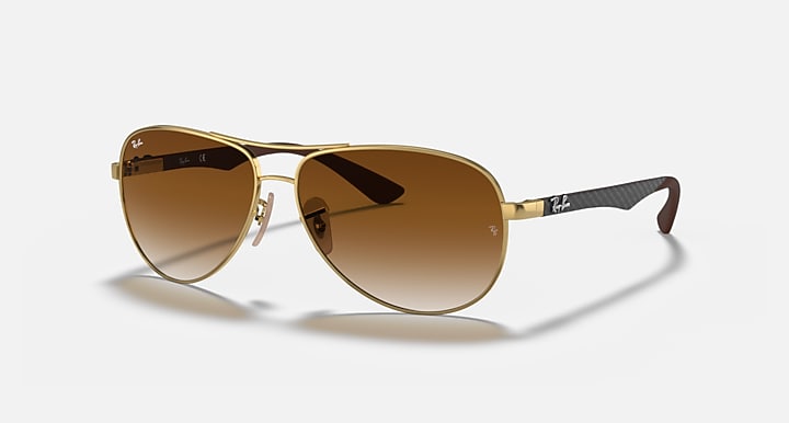 Ray-Ban aviator sunglasses with gold frame and brown gradient lenses