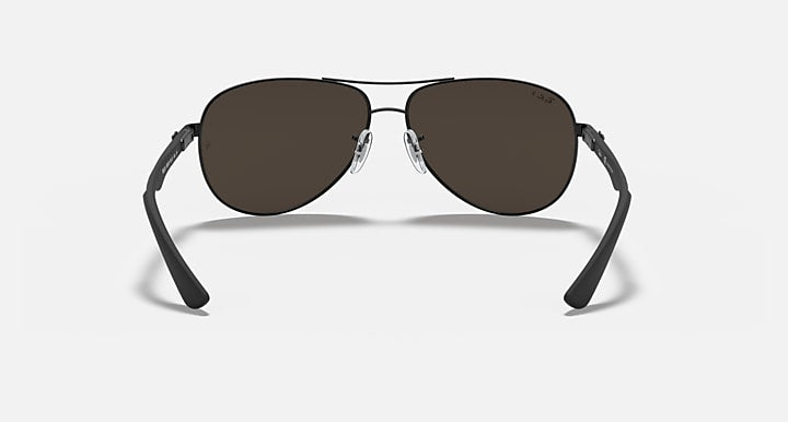 Ray-Ban aviator sunglasses with dark frame and dark brown lenses, metal bridge