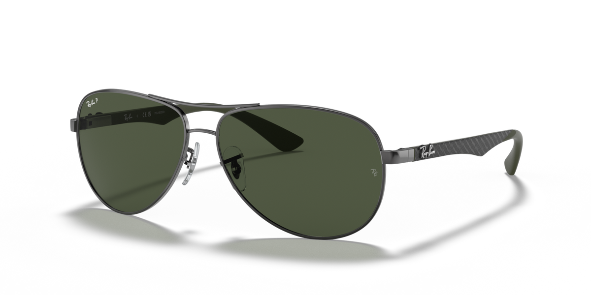 Ray-Ban aviator sunglasses with dark green lenses and metal frame, angled side view