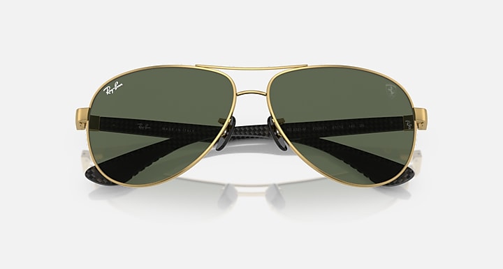 Gold-tone aviator sunglasses with dark green lenses and polarized mirrored band
