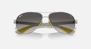 Silver-tone aviator sunglasses with dark gradient lenses and yellow bridge accents