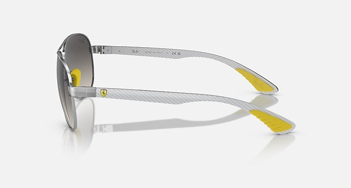 Silver-tone aviator sunglasses side view with smoke lenses and yellow temple tips