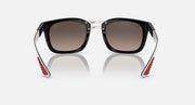 Ray-Ban sunglasses, front view with black frame and metal hinges, red temple tips