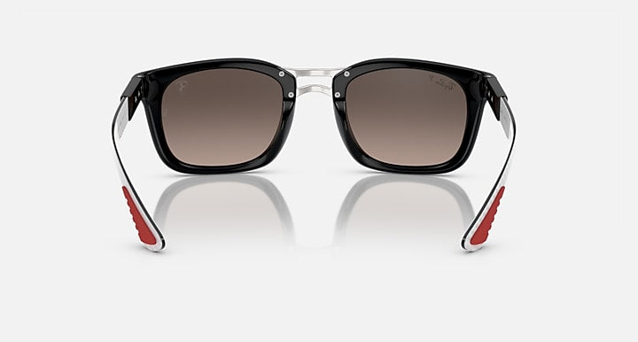 Ray-Ban sunglasses, front view with black frame and metal hinges, red temple tips