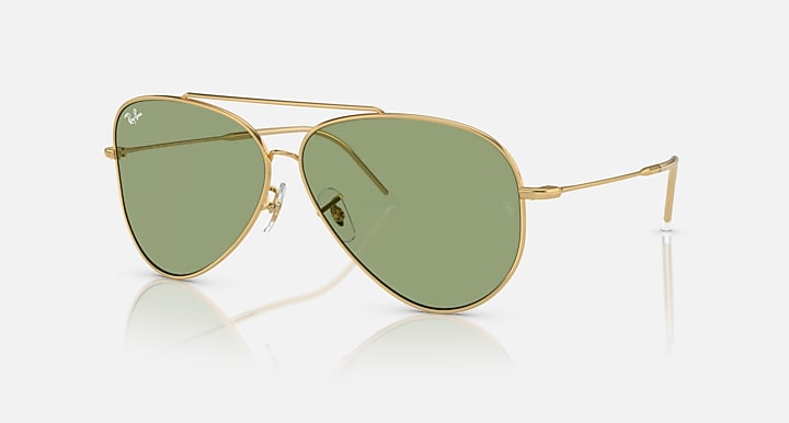 Ray-Ban aviator sunglasses with gold frame and green tinted lenses, teardrop shape.