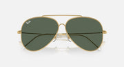 Ray-Ban aviator sunglasses with dark green lenses and gold frame, close front view.