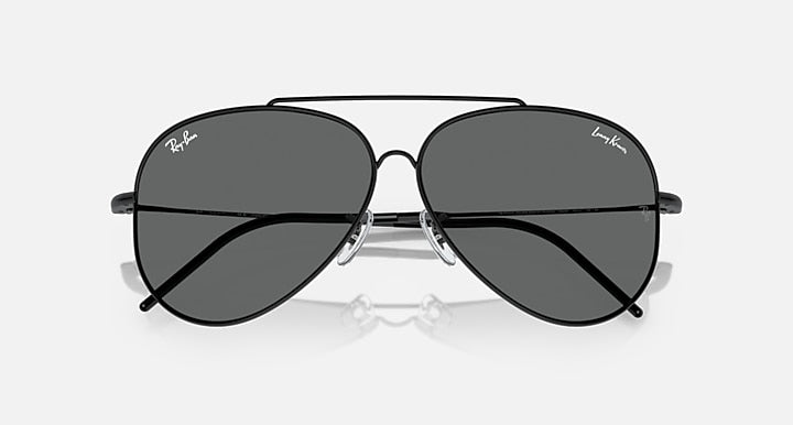 Aviator sunglasses with dark gray lenses, showing bridge and metal hinges